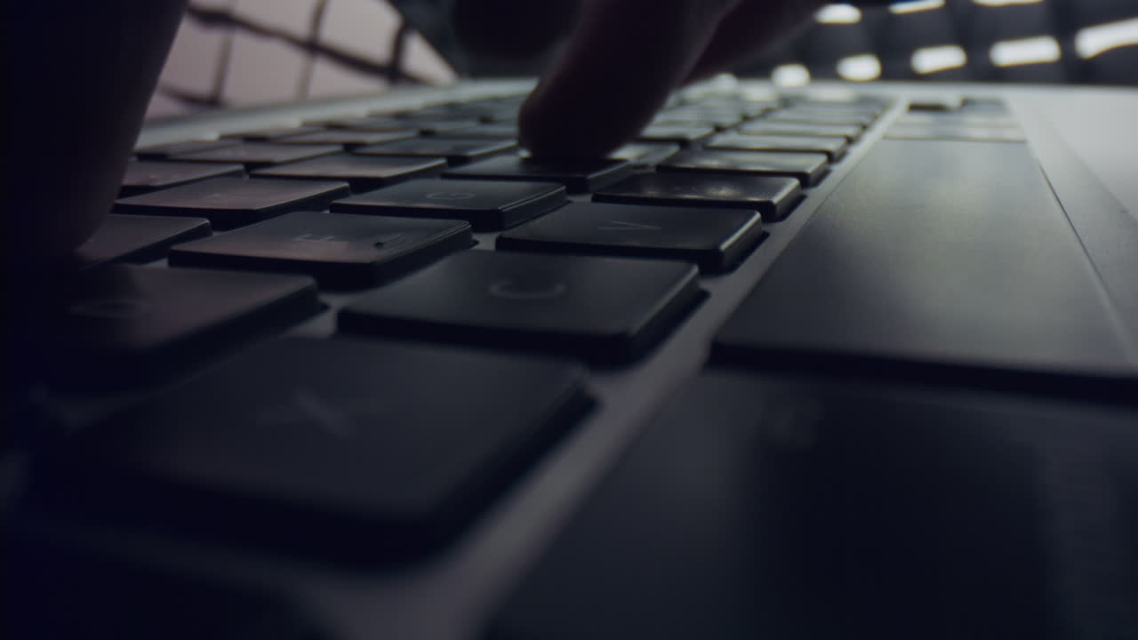 Male fingers typing on laptop keyboard. Man hands using laptop computer