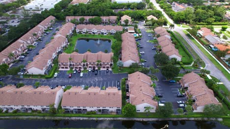 wide aerial over warm suburban neighborhood with trees, streets and peaceful homes