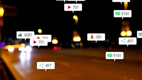 Animation-of-social-media-icons-and-numbers-over-out-of-focus-city-and-traffic-lights