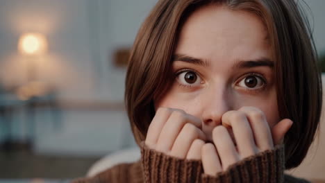 young woman expressing shyness or fear while hiding her face
