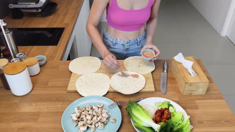 preparing chicken wraps with salad