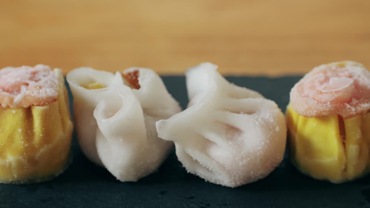 Various of frozen dim sum close-up macro. Food to take away. Chinese dessert food. Dimsum with shrimps, fish and meat. Dish in a cafe. Delivery