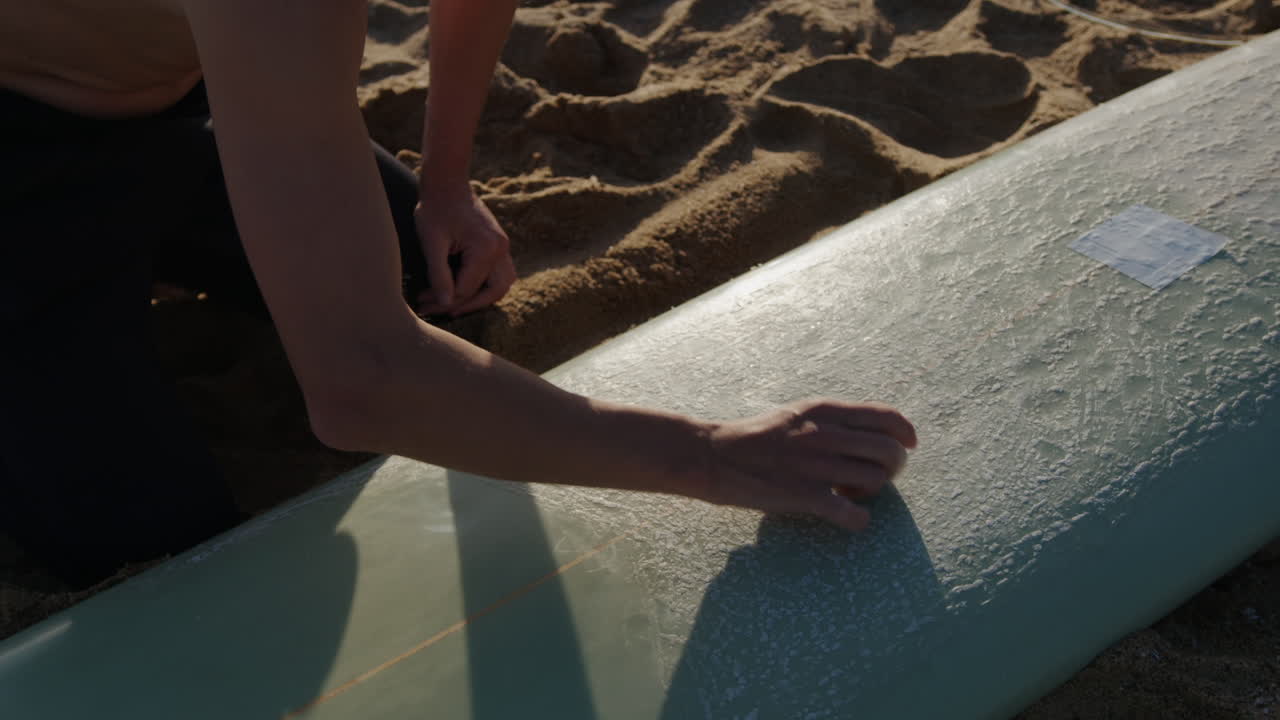 Surfer man walking to the beach at sunset preparing for surfing training and search for waves in Barcelona, spain, water, ocean exercise in sea with board, athletic male holiday or travel in vacation