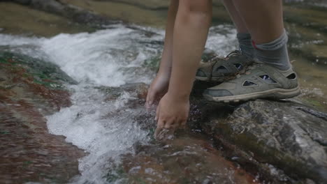 person playing in a creek