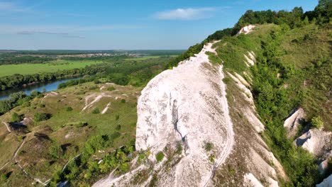 aerial view of a white cliff and valley landscape.