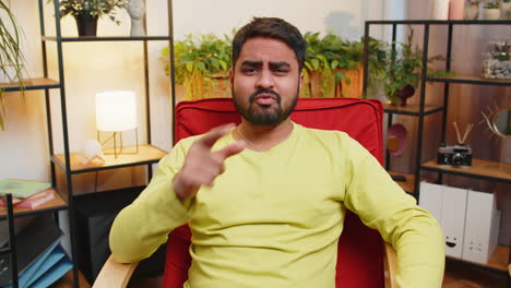 upset sad indian man making face palm gesture feeling bored disappointed in fail bad results news