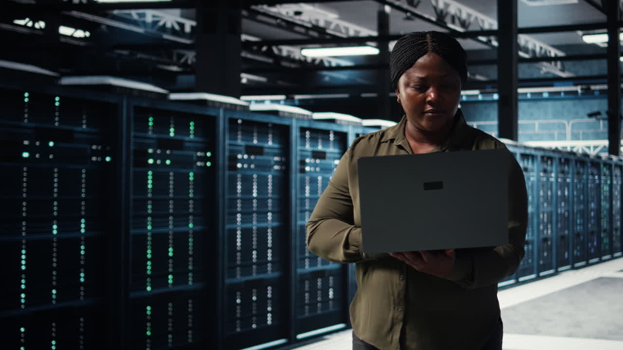 Data center system administrator uses laptop to develop disaster recovery plans