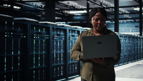 data center system administrator uses laptop to develop disaster recovery plans