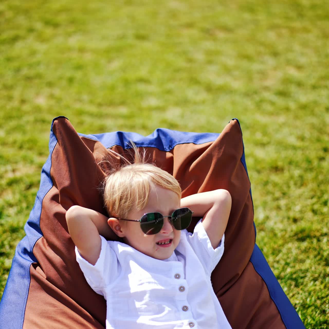 Young little child in the garden. Cheerful cute boy having fun outdoor