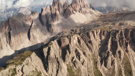 Aerial-view-overlooking-the-Croda-Da-Lago-mountain-with-clouds-and-sun