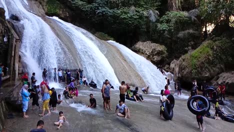 people enjoying a refreshing day at a beautiful waterfall