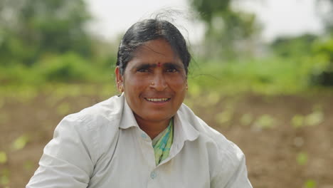 a woman farmer planting in a field