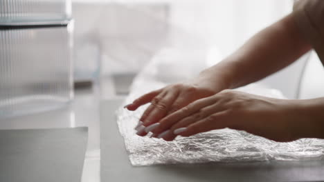 woman relieves stress popping bubbles on bubble wrap