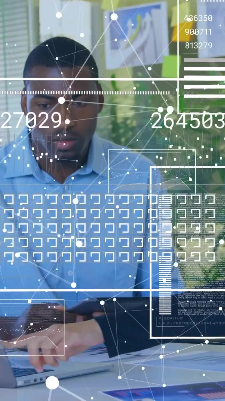 Vertical video: Analyst using tablet while coworker tapping laptop building AR charts for business
