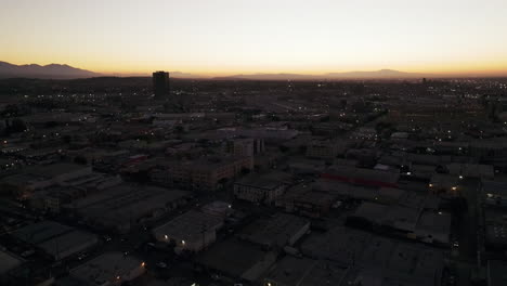 aerial view of a city at dusk with distant mountains