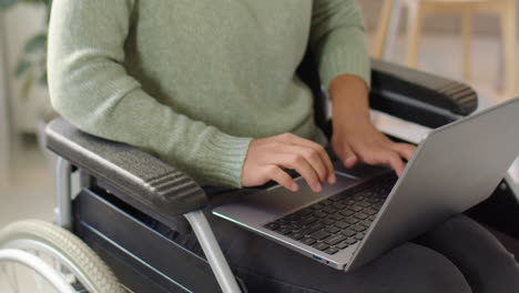 woman using a laptop in a wheelchair