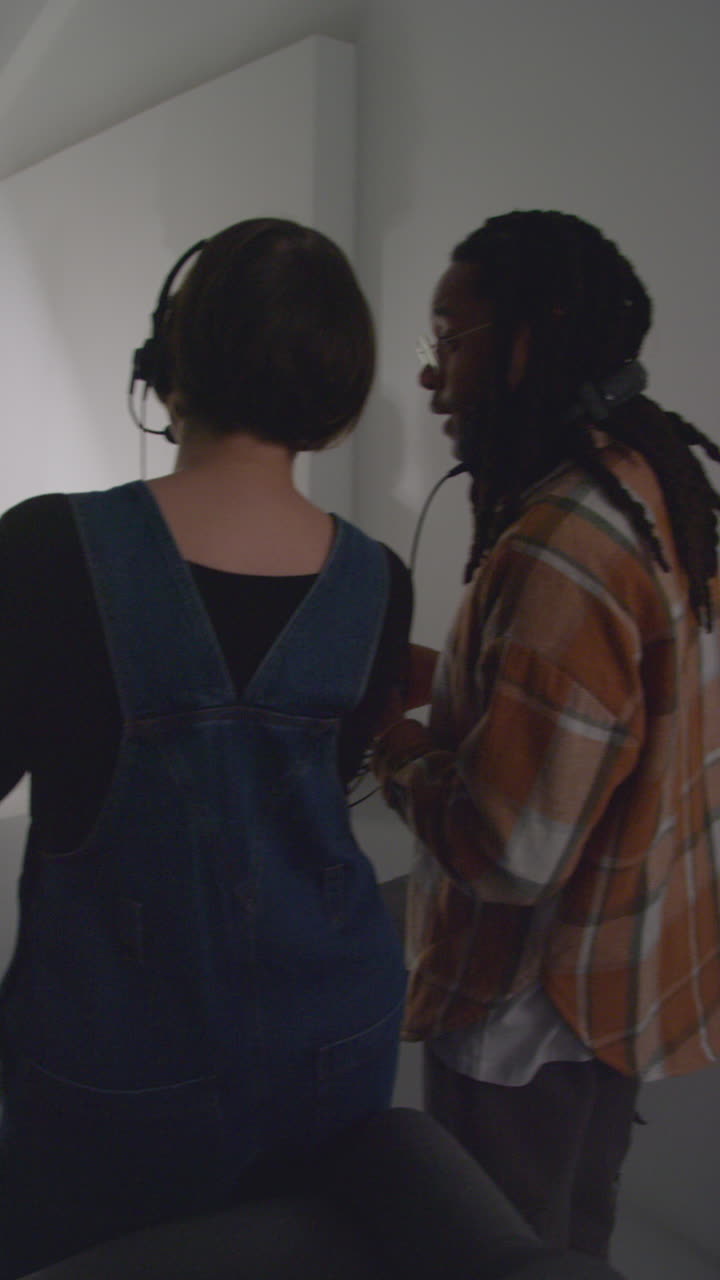 Vertical Video Of Actors With Scripts In Rehearsal With Female Film Director Shooting Movie Or Video In Studio With Film Crew And Watching On Monitor 1