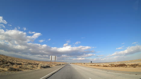 A-view-from-the-rear-window-of-a-vehicle-traveling-down-a-southern-California-highway---hyper-lapse