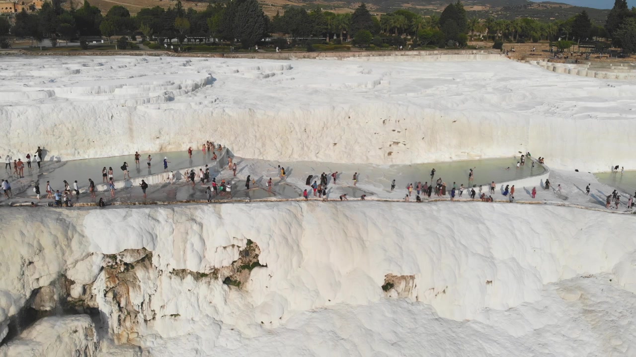 Tourists Visiting the White Travertine Terraces of Pamukkale in Turkey