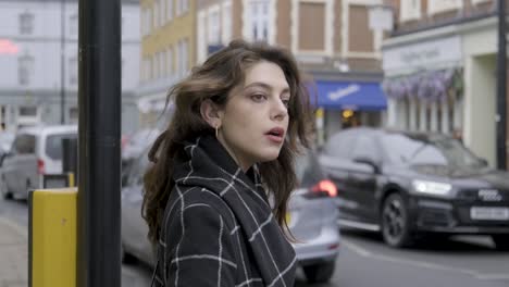 brunette businesswoman waiting and trying to cross busy traffic street crosswalk in central london