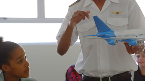 pilot giving training about model aeroplane to kid 4k