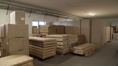 warehouse interior with stacked flat pack furniture ready for distribution
