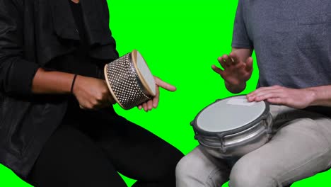 Mid-section-of-musicians-playing-cabasa-and-drum