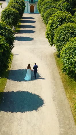 newlywed couple walking in a beautiful garden