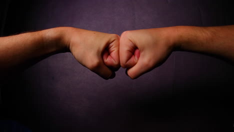 male fists touch each other close up side gesture captured from left side looking gracefully in front of camera fisheye perspective with daylight all capture in 4k 60fps slow motion movement