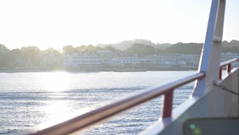 coming-into-port-of-Mackinac-Island,-Michigan-by-ferry-during-glowing-sunset