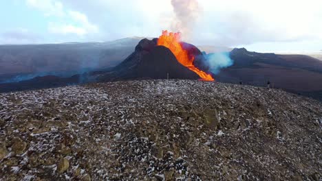 amazing drone aerial as tourists watch the dramatic volcanic eruption of the fagradalsfjall volcano on the reykjanes peninsula in iceland