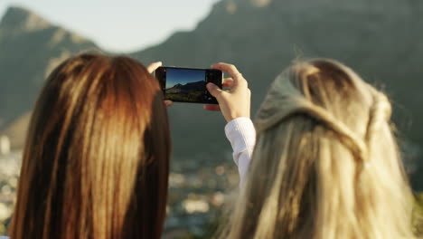 two female best friends taking a picture in nature