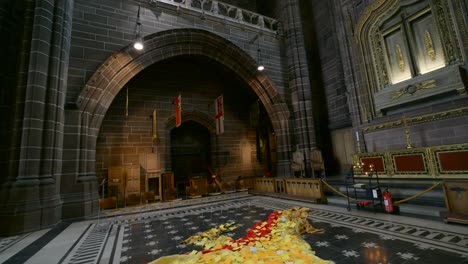 red and yellow poppies form a wave installation inside liverpool cathedral, commemorating remembrance day