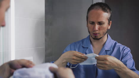 doctor-in-intensive-care-suit-in-front-of-mirror