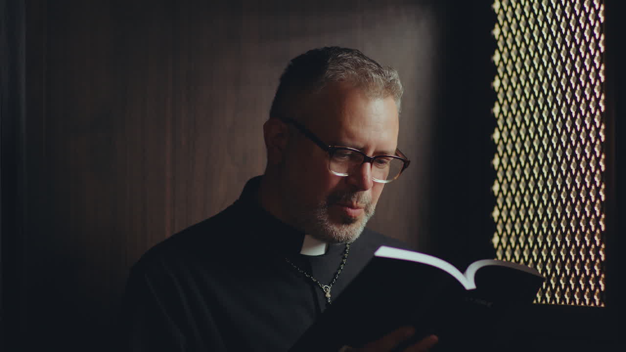 Catholic Priest Reading Bible to Penitent during Confession