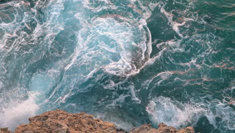 powerful waves crashing against coastal rocks