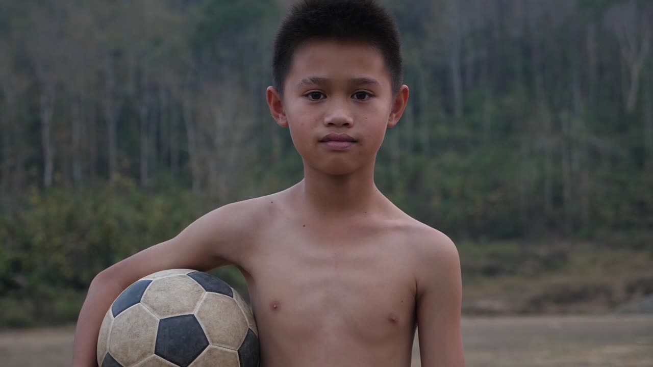 Young Boy Holding Soccer Ball