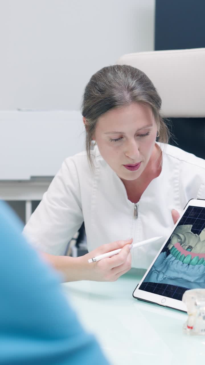 Dentist Explains Dental Procedure on Tablet