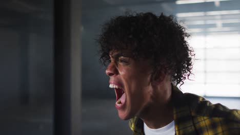 Mixed-race-man-protesting-in-empty-parking-garage