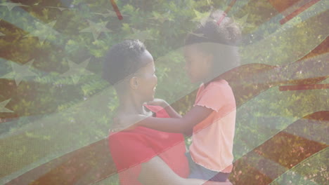 animación de la bandera de los estados unidos sobre una mujer afroamericana caucásica con su hija