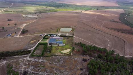 Aerial-shot-of-a-farm-house-with-a-pond-in-South-Africa-countryside-rural-lands