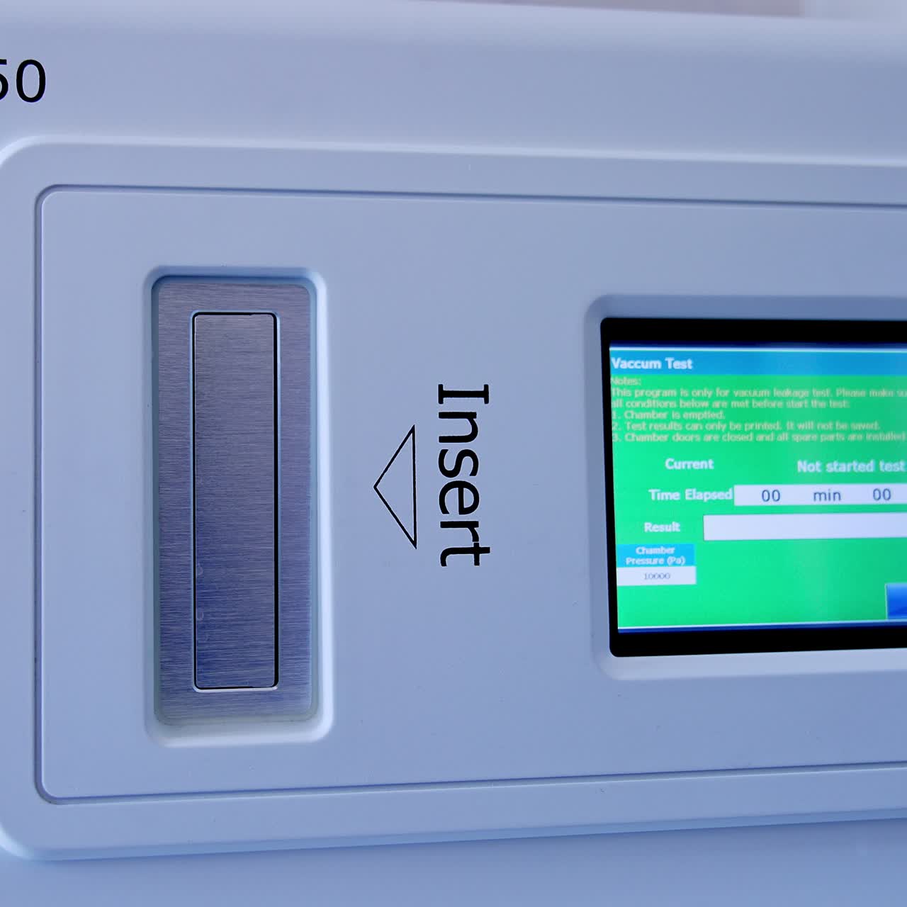 Touch screen panel switched on at the equipment for sterilization. Gloved hand of medic presses keys to start the procedure of disinfection