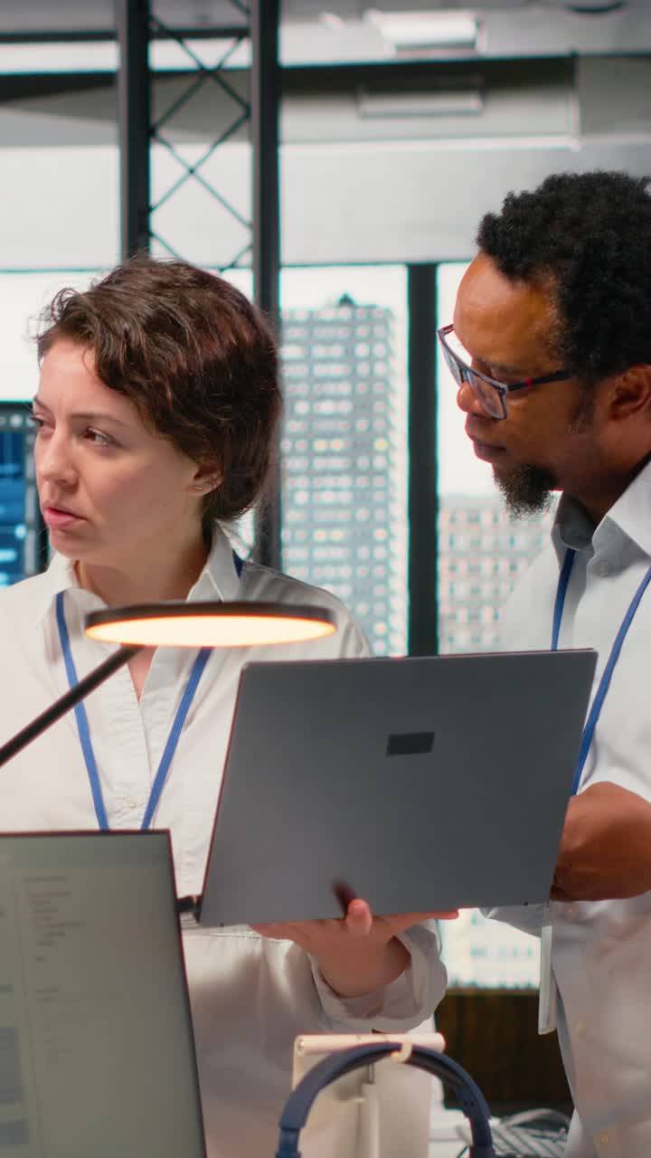 Vertical video Engineering team working together in office, using AI specialized hardware