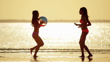 multi ethnic girls on tropical beach at sunrise