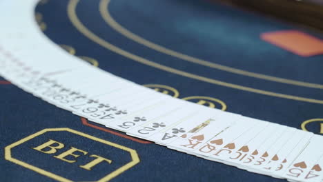 close up of hands of dealer with playing cards on pocker table