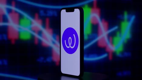 Energy-Web-Token-on-iPhone-with-candlestick-price-in-the-background