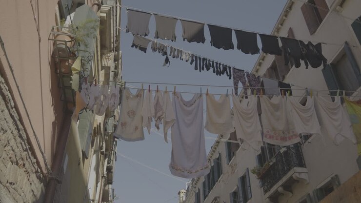 Laundry hanging from clothesline in a Venetian alleyway