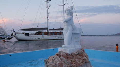 the sculpture of the mermaid of aktio in the marina