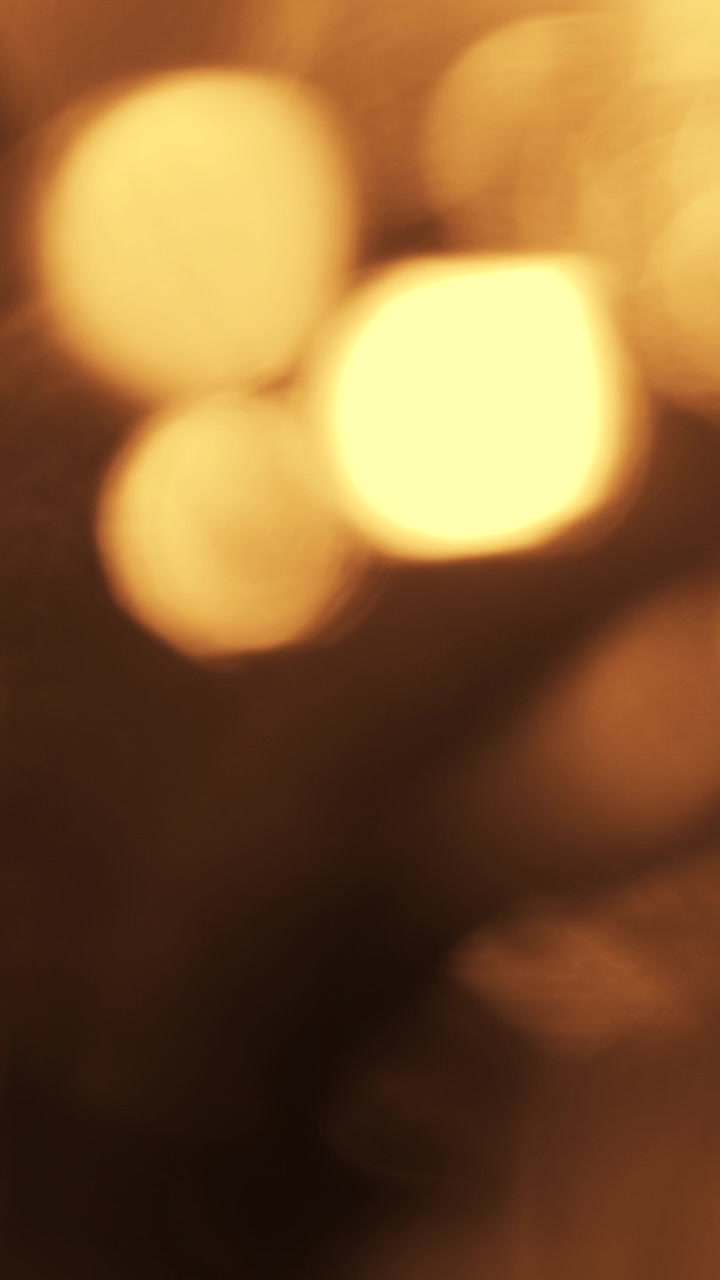 Abstract Golden Light Bokeh Transitions on Black Background