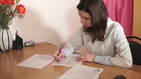 Doctor signing a document with patient